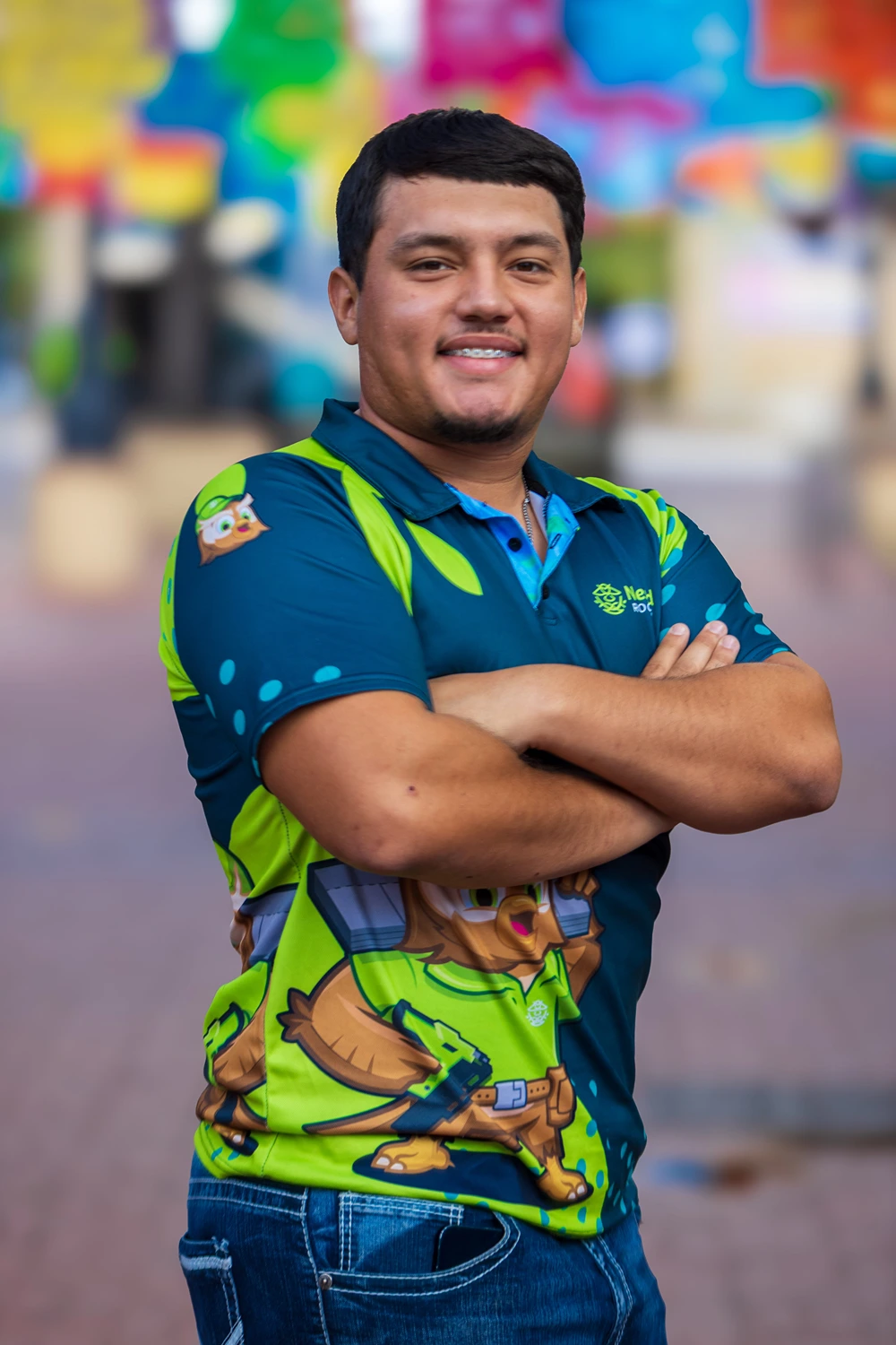 Jose Ortiz, Co-Owner of Nestled Roofing, standing with arms crossed and smiling